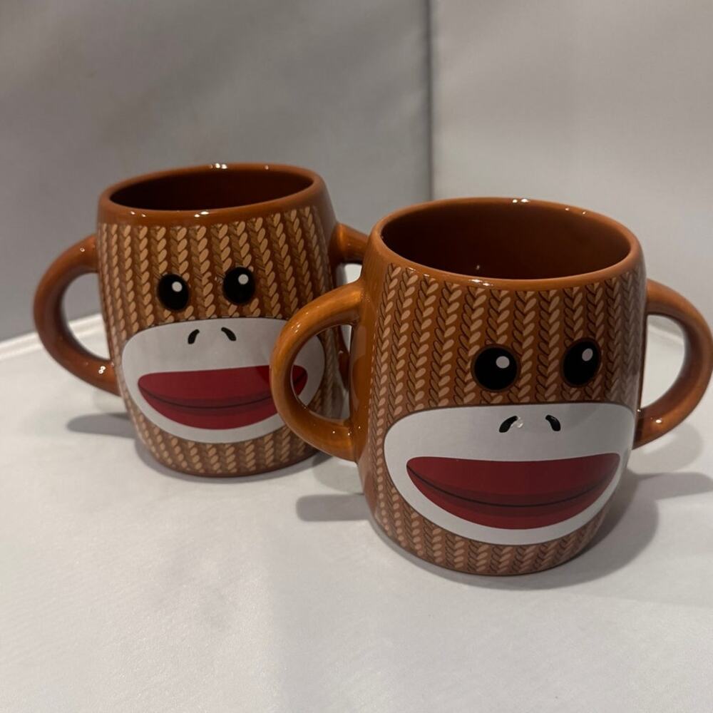 Pair‎ of brown Galerie two-handle ceramic sock monkey mugs